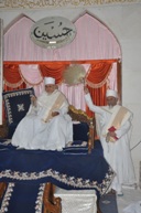 Huzoor-e-'Aali Saiyedna saheb (tus) on Takht-e-Taiyebi while Mazoon ud-Da'wat doing khidmat of Chammar